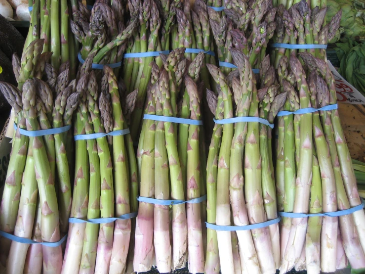 a pile of asparagus are tied to a display