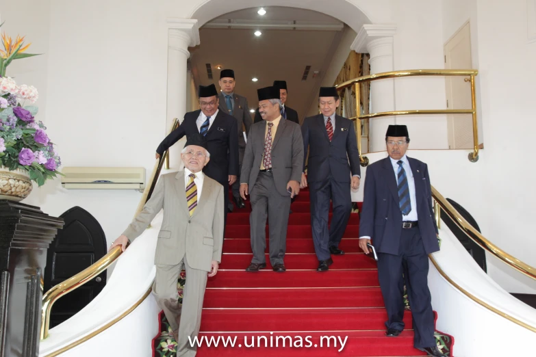 men walking up stairs dressed in formal attire