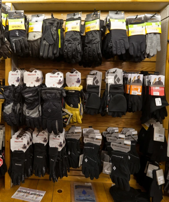 the store display features several pairs of winter gloves