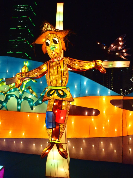 a lighted inflatable figure stands on the ground in front of a large building