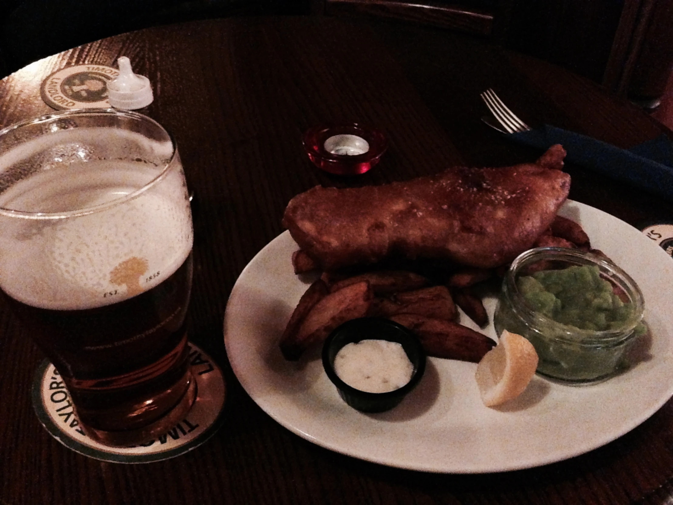 a table with a plate of food and beer