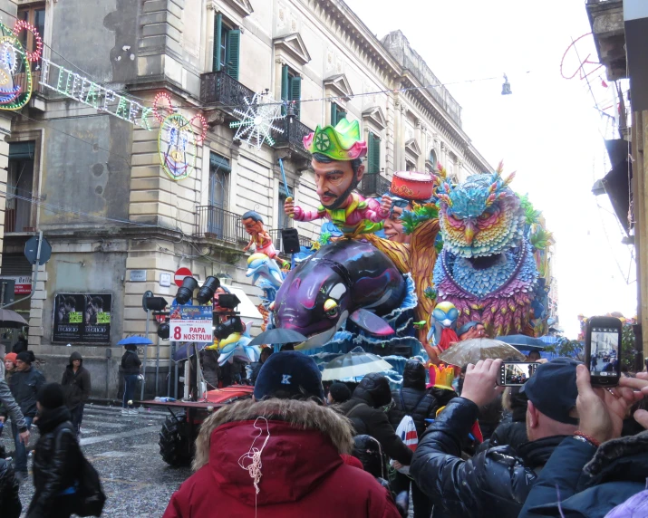 several large colorful float in the middle of the city