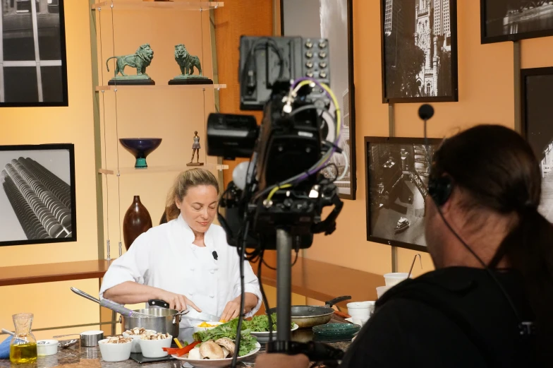 a woman is making food in a kitchen