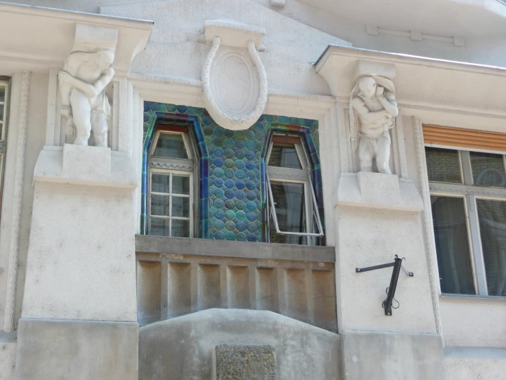 ornate architecture on the side of a white building