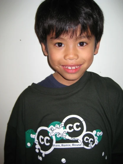 a boy with black shirt smiling at the camera