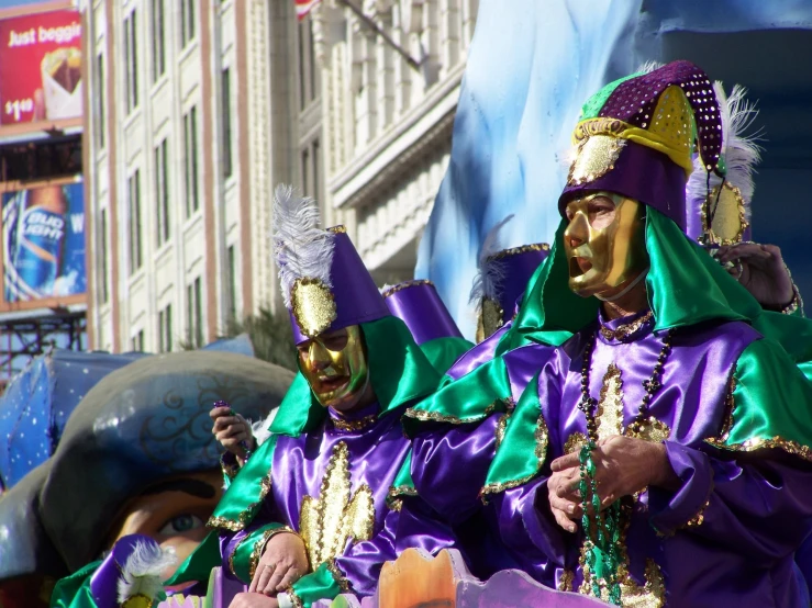 a couple of people in costumes with faces painted gold