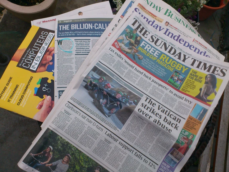 a newspaper with several different news papers on it