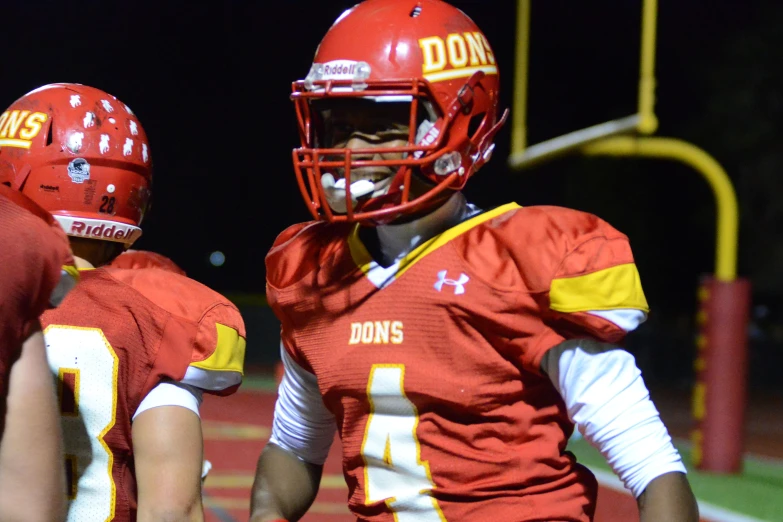 two football players with helmets on a field