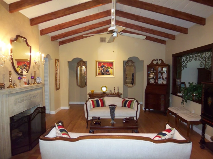 an old living room has vaulted wood beams