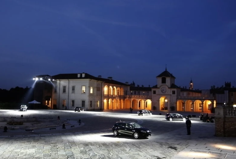 a black car is parked near a building