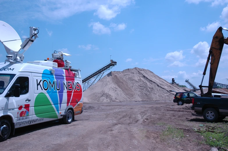 a colorful van parked in front of a pile of dirt