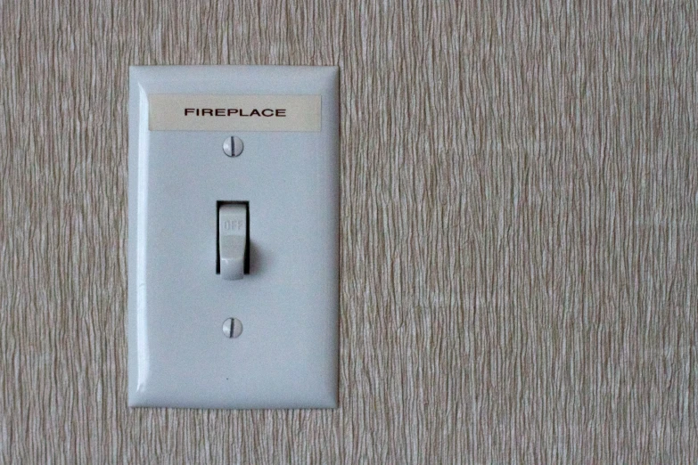 a wall switch is pictured here next to some sort of textured paper
