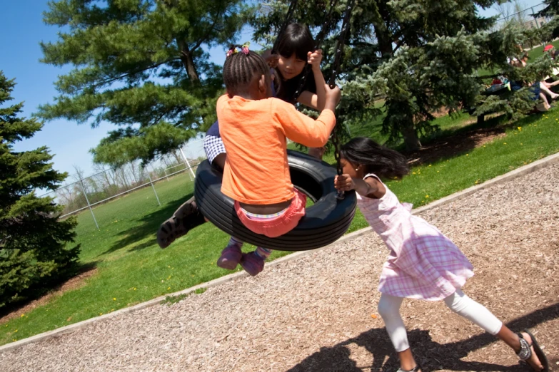 two girls standing next to each other in a playground