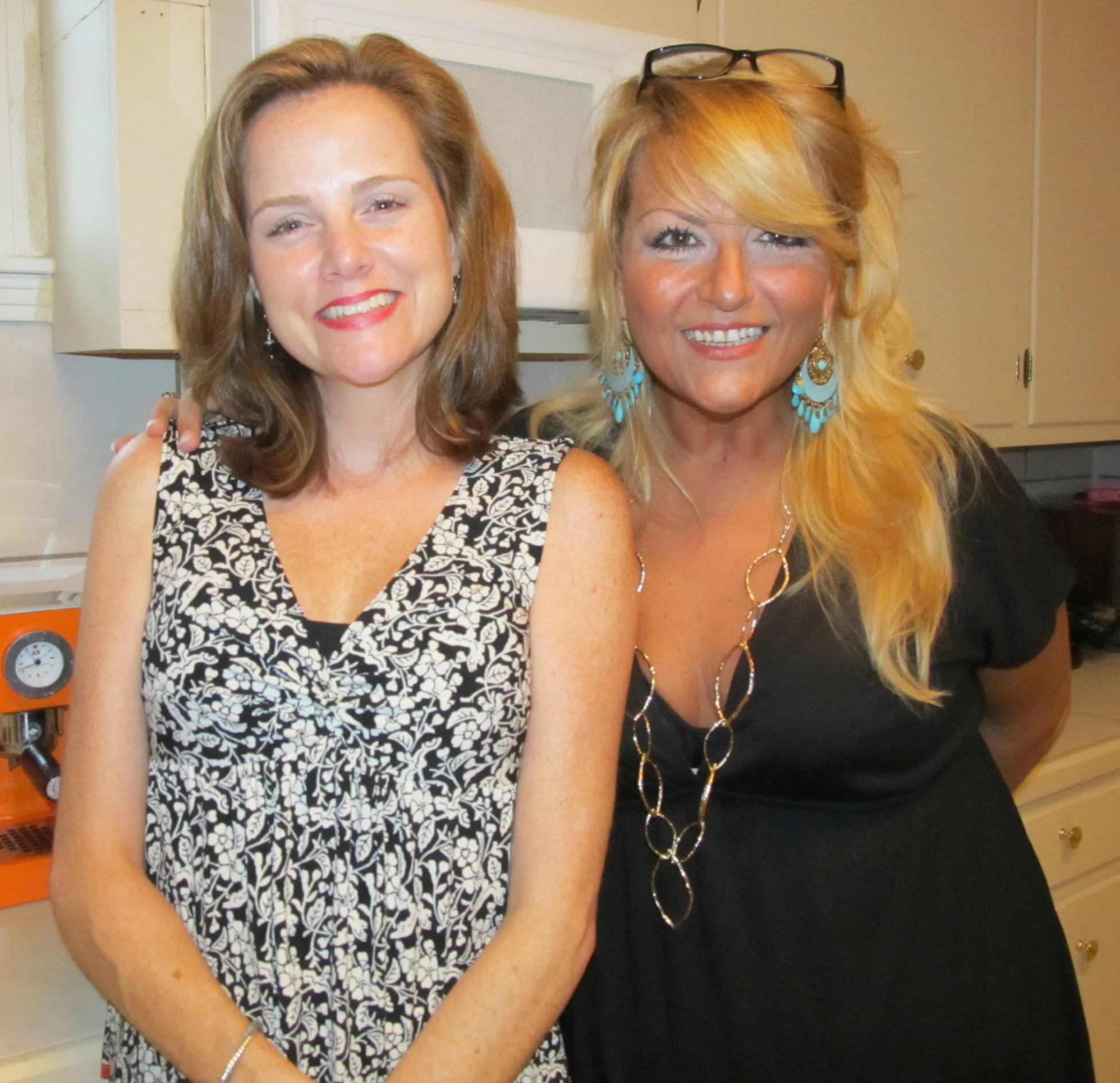 two woman in a kitchen posing for a picture