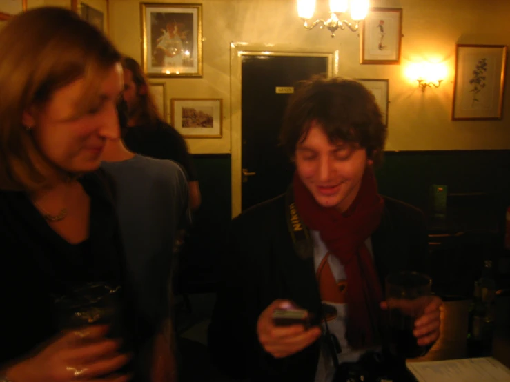 two people standing next to each other in a restaurant