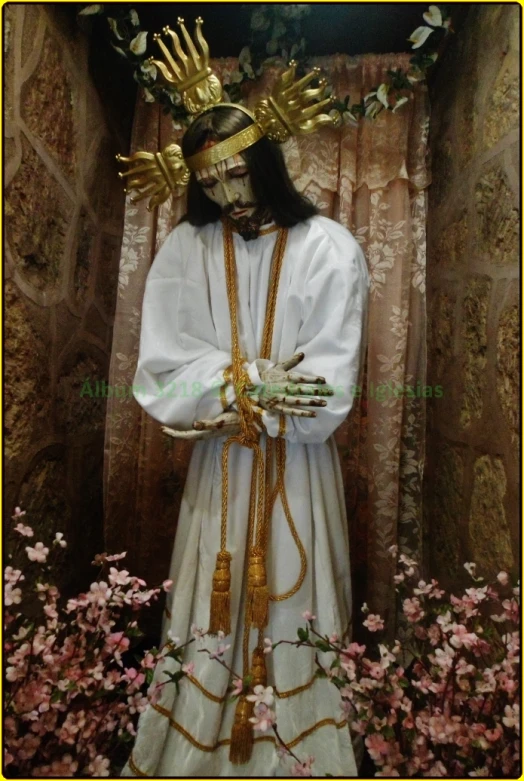 a man with long hair and wearing a crown in a statue