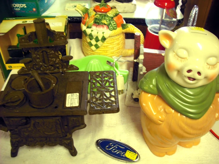 a little white bear statue next to two old and broken toy sets