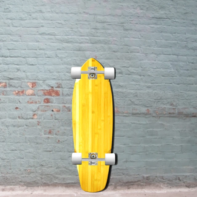 a yellow skateboard sitting against a brick wall
