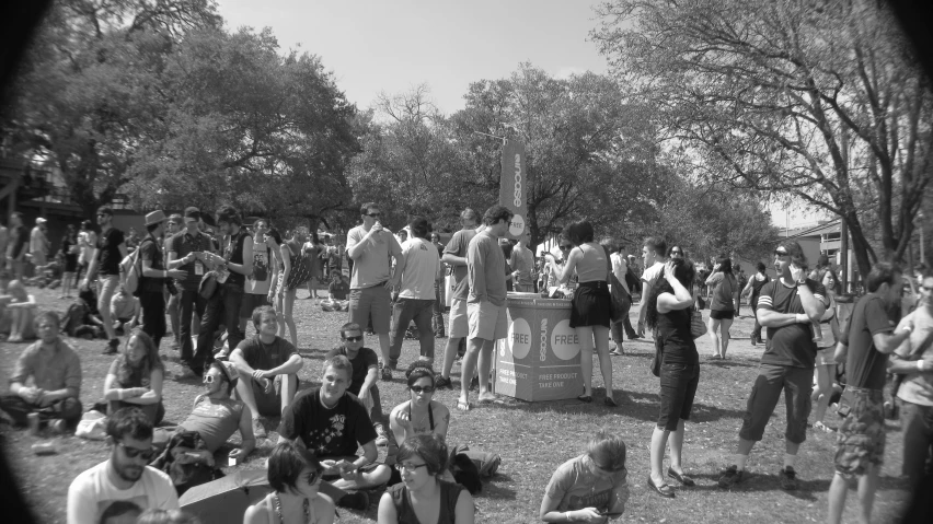 a group of people standing around a group of trees