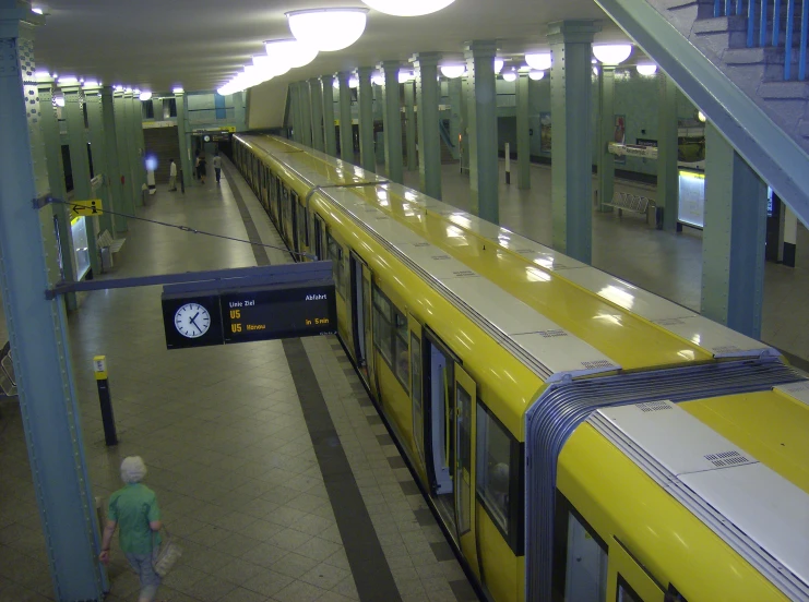 a long yellow train traveling down train tracks