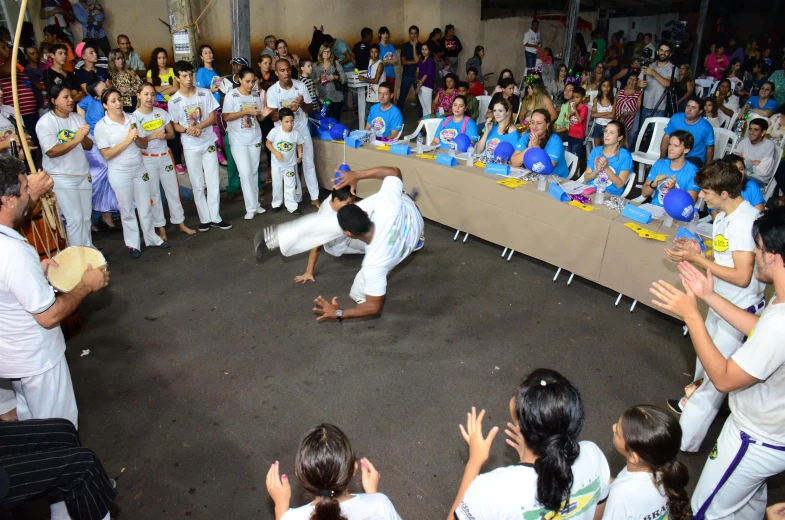 the young man is doing tricks in front of a crowd