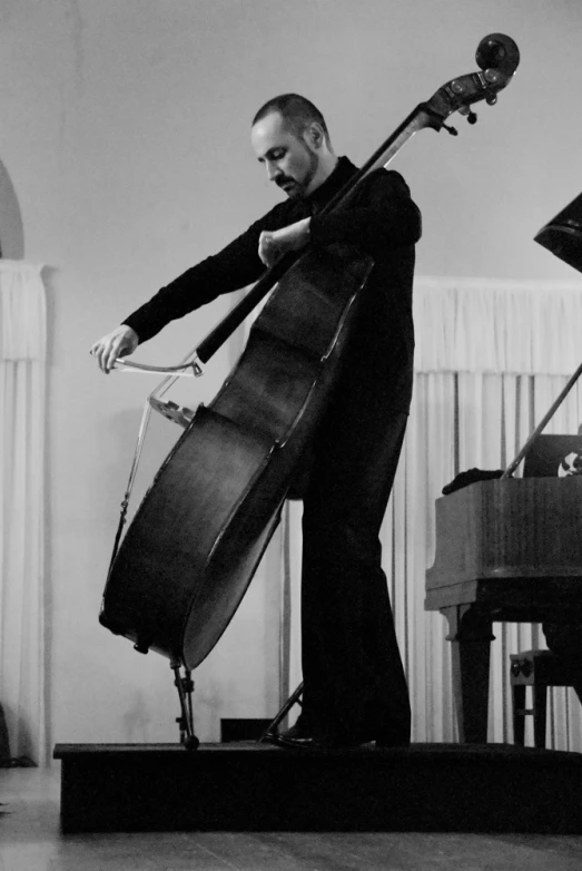 a man playing the cello on stage