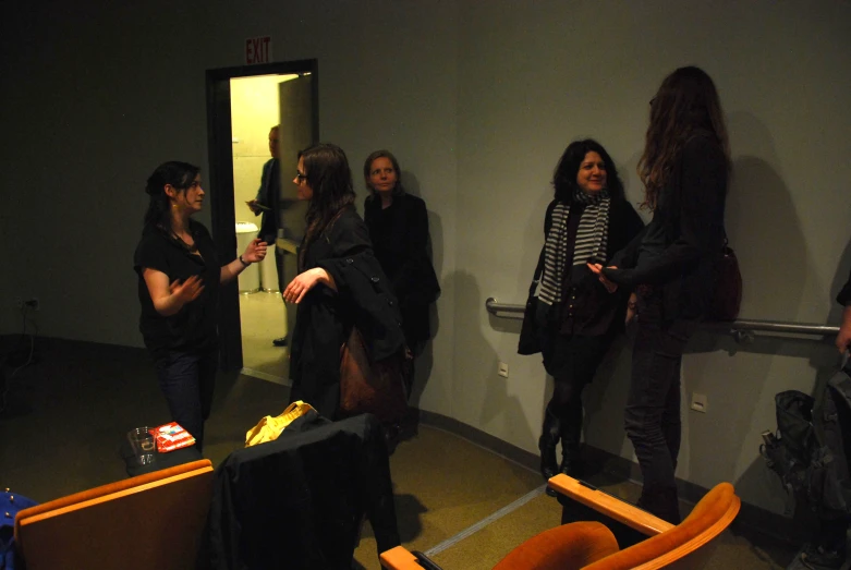 several people standing near an open elevator