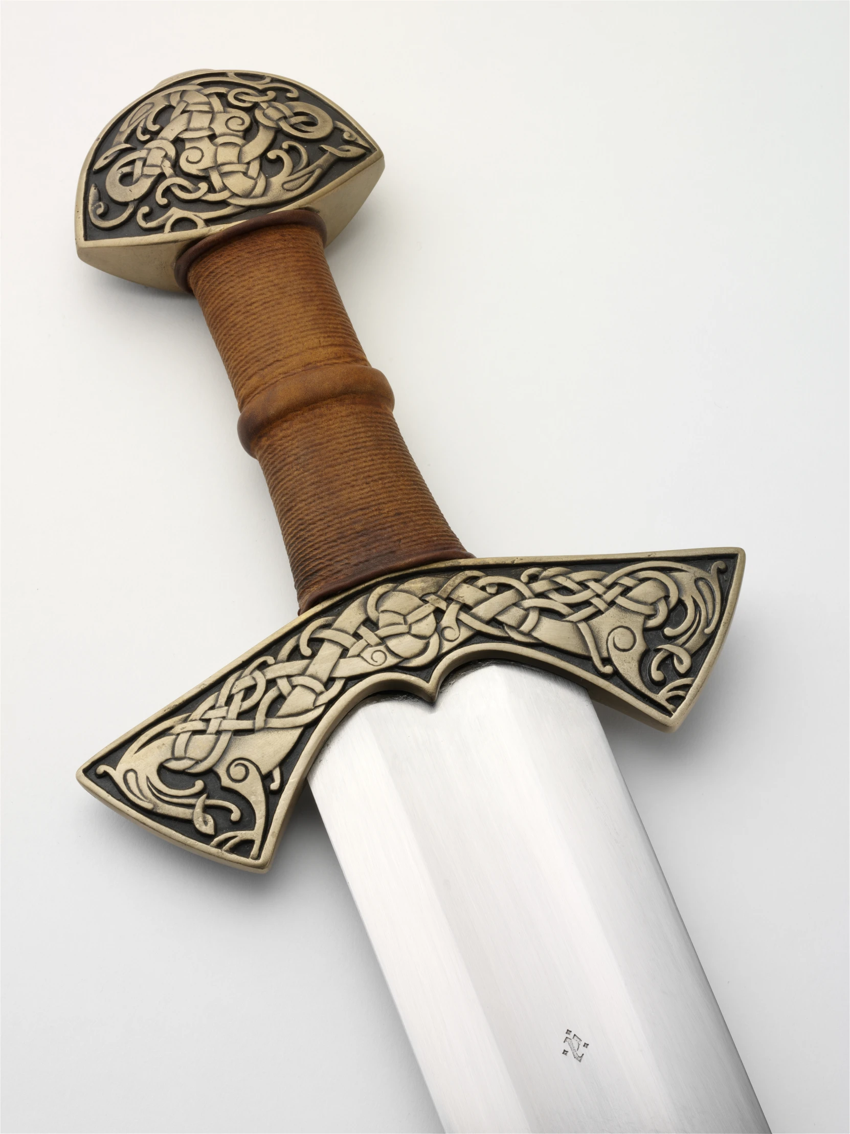 a leather handle knife with intricate iron work