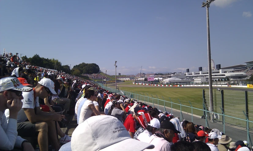 people at a racing track sitting and standing