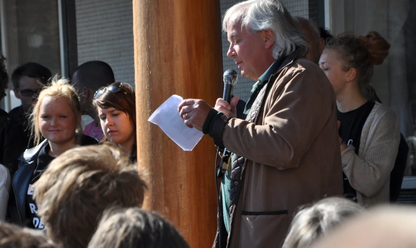 a man is giving an audience a speech