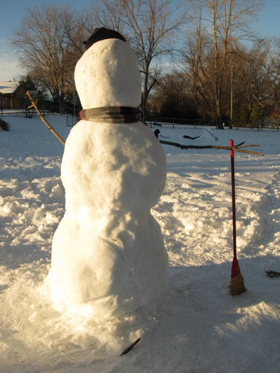 snowman stands in front of small tree