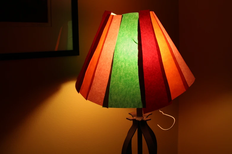 a colorful lamp sitting on a table in a corner