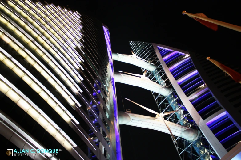 an image of some tall buildings at night