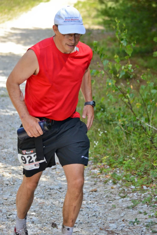 a man running and holding the shoe compartment of his shoes