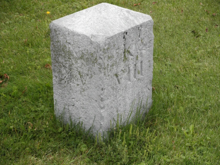 an old block that has been placed in the grass