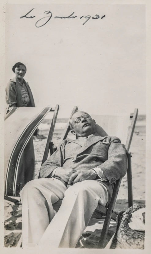 black and white pograph of a man in a chair