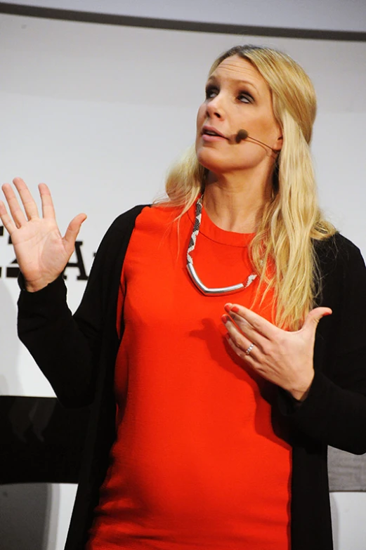 a woman speaking in front of an audience