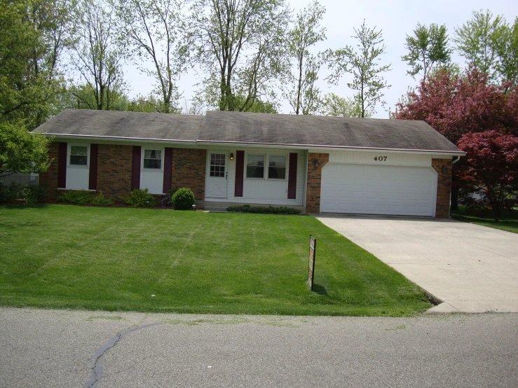 a small house with a garage in the driveway