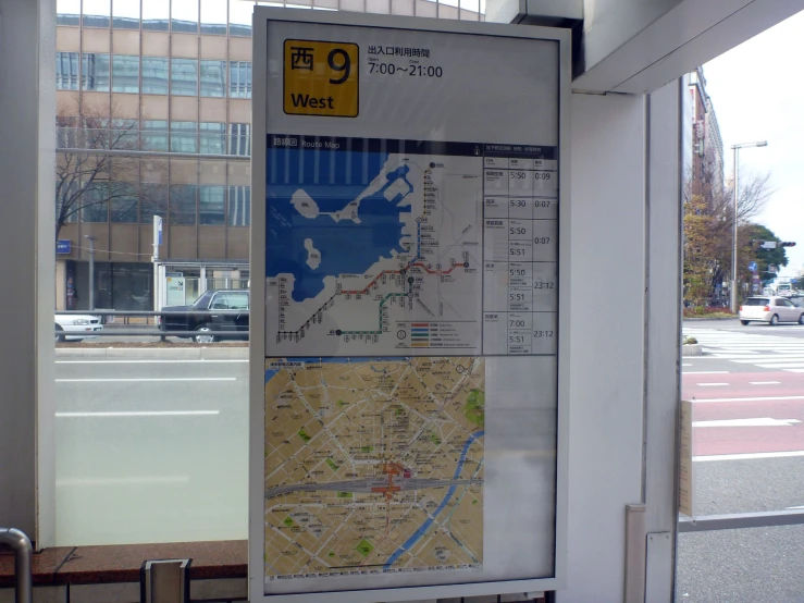 a bus stop area with a map on a window