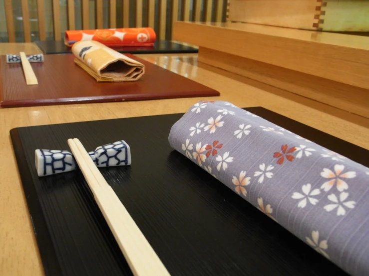 two rolls and chopsticks laying on the floor