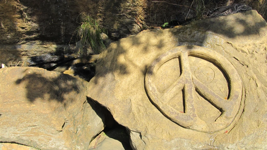 peace sign is carved into the rocks on this cliff