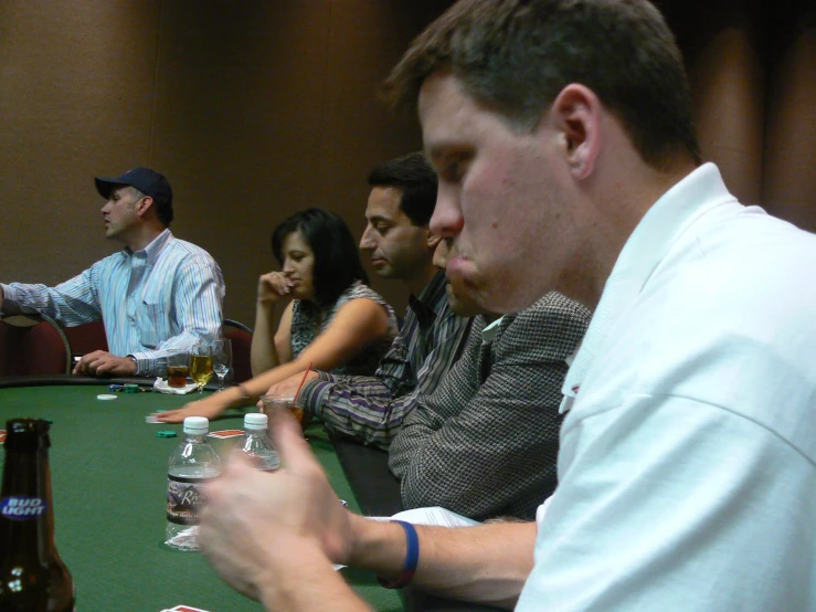 a group of people at a table with bottles