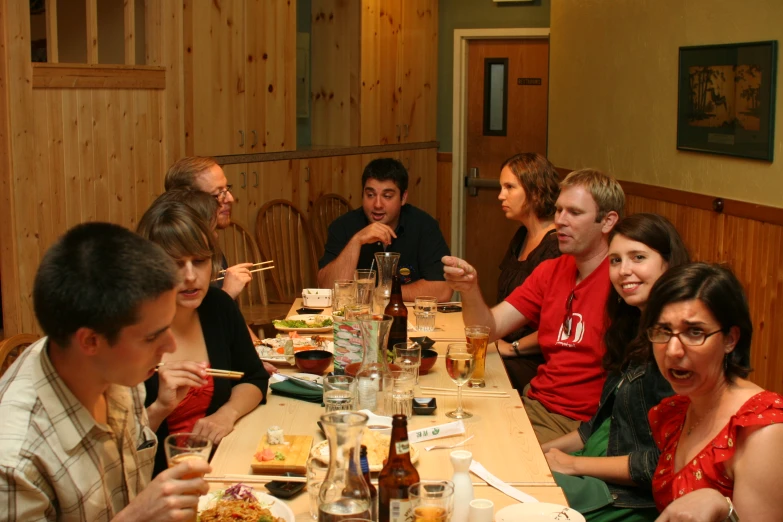 a group of people sitting at a table eating