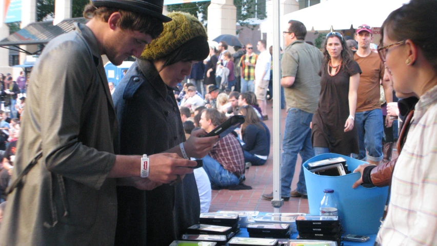 a man standing next to a women on a phone