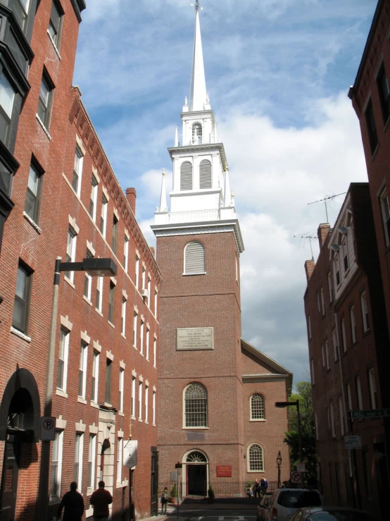 the steeple of a building is in the middle of this street