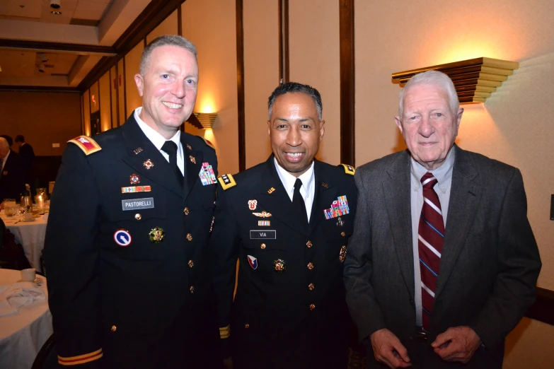 three men in uniform standing side by side