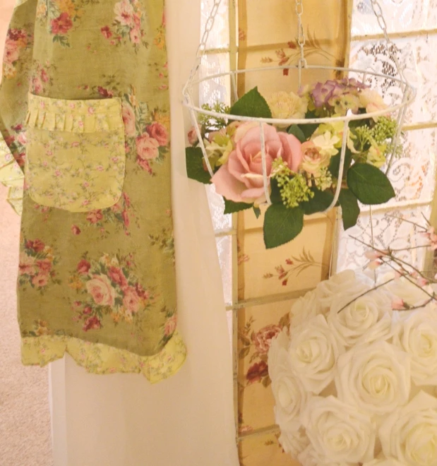 three pink flowers are on top of a metal rack