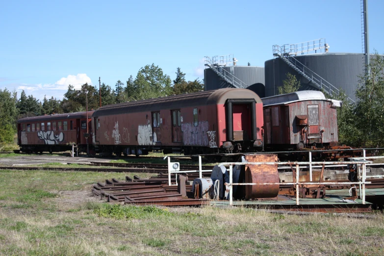 an old train on tracks sitting in an open field