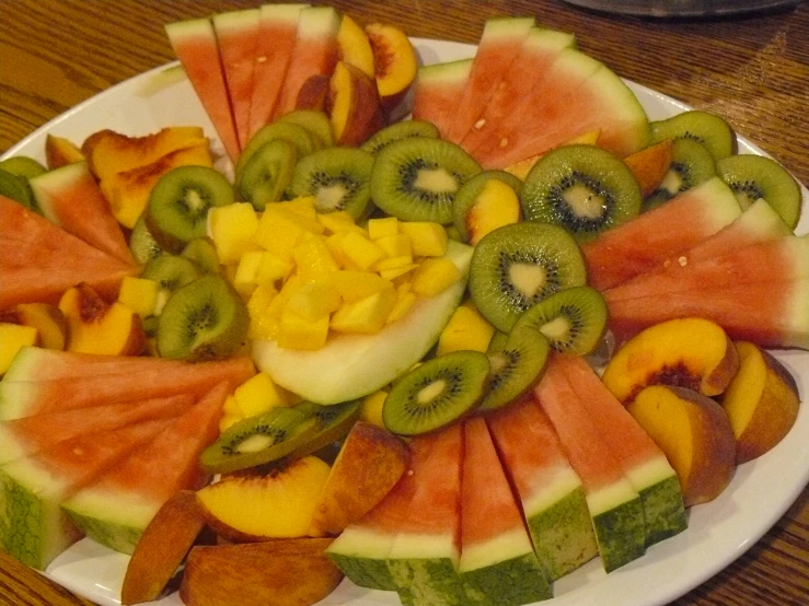 this plate has cut into several different kinds of fruit