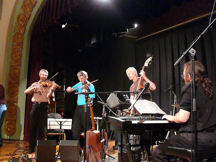 a group of people playing musical instruments on stage